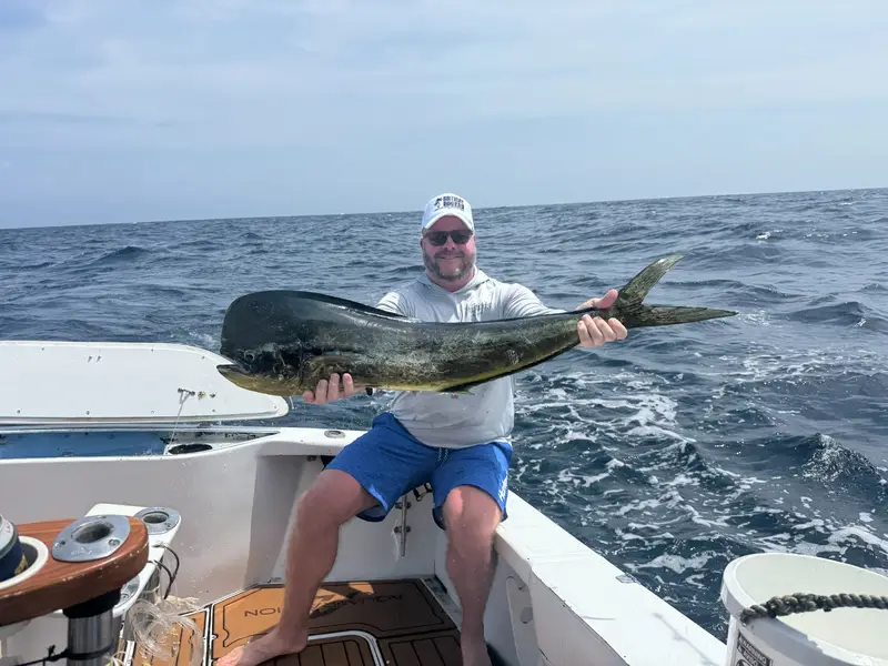 Happy angler with mahi-mahi